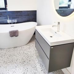 Cosmic Terrazzo and Paris Navy Brick wall tiles in contemporay bathroom with freestanding bath.