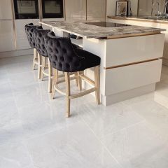 Florence ivory 600x600mm floor tiles fitted in a contemporary kitchen with bold marble island