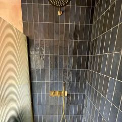 Monaco navy brick wall tiles in a luxury shower