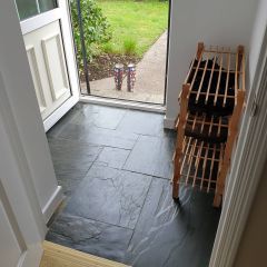 Natural charcoal grey slate modular set fitted in a modern entrance porch with wellington boots