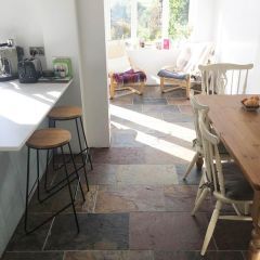 Sheera multicolour 600x400mm natural slate tiles in a  sunlit country kitchen dining area