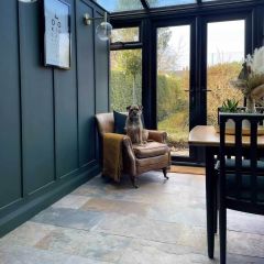 Sheera multicolour natural slate tiles fitted on a conservatory floor with dog sat on leather chair