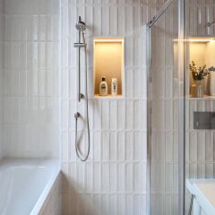 Verda ivory brick wall tiles in linear straight stack style in a bright contemporary bathroom with shelf.