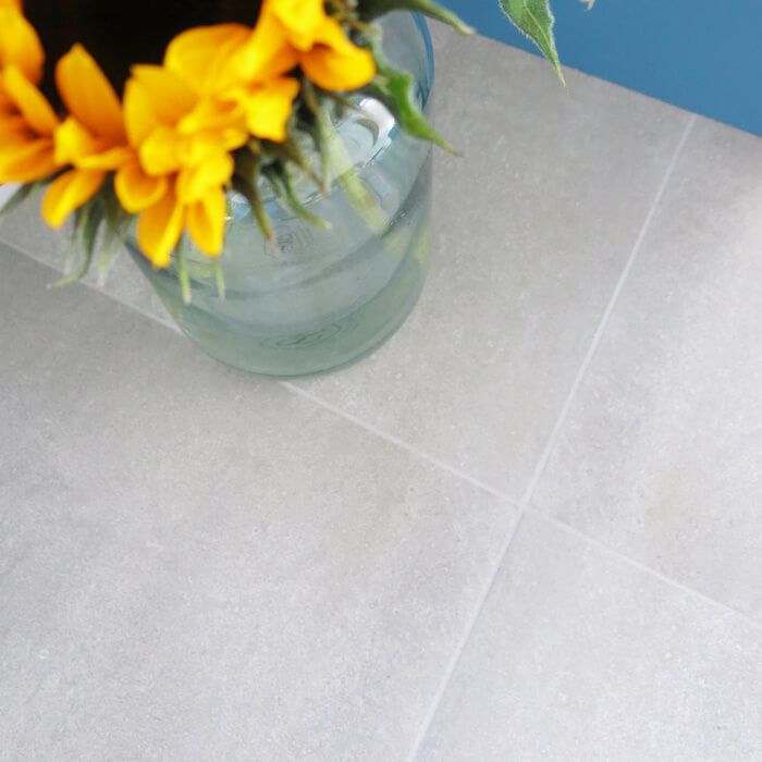 Urban grey concrete cement effect floor tiles in a contemporary kitchen setting