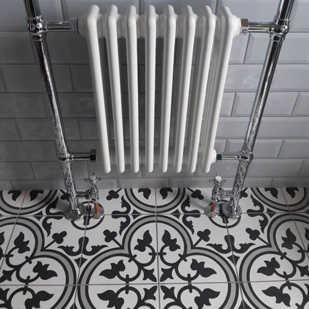 Madeira grey patterned floor tiles in a small bathroom with vintage style radiator