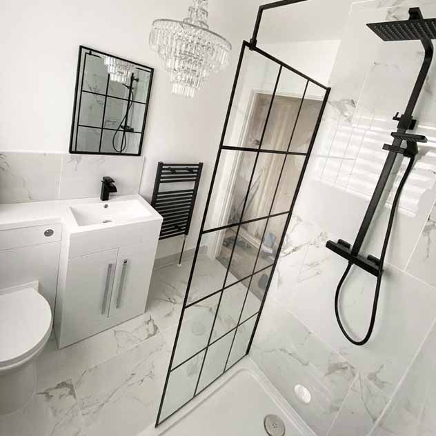 Carrara white marble porcelain floor tiles in a bathroom and shower space