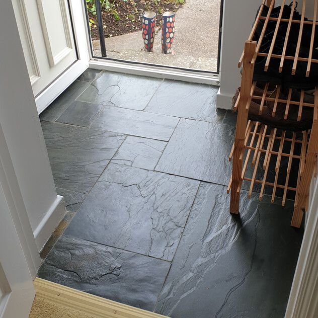 Natural charcoal riven slate modular set in an entrance space 